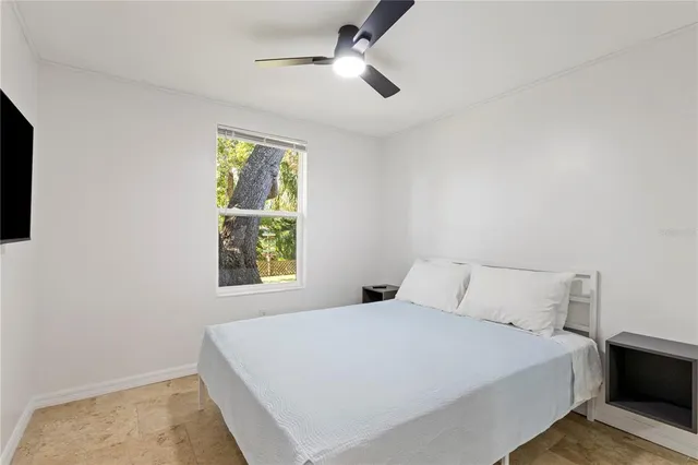 a bedroom with a bed and a window