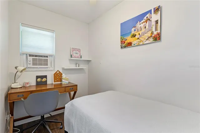 a room that has a bed and a desk in it