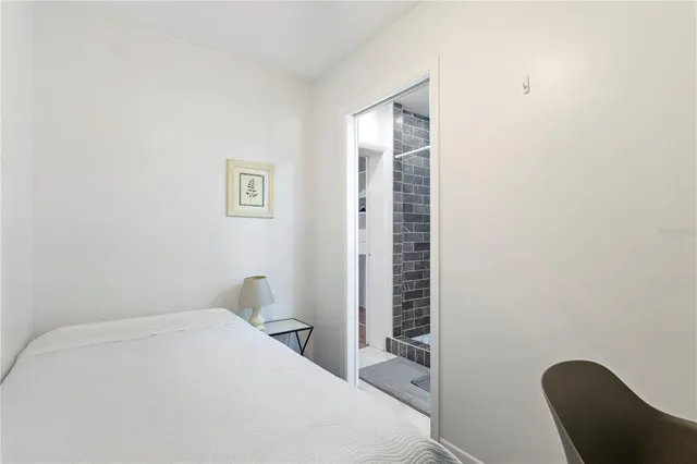 a bedroom with a bed and a chair