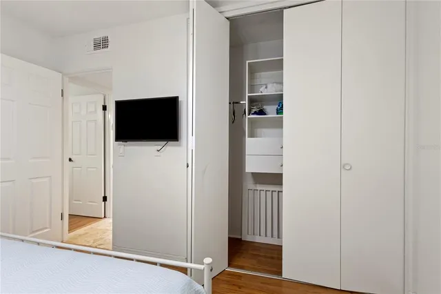 a view of a livingroom with wooden floor and a flat screen tv