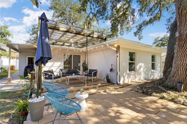 a front view of a house with garden and patio