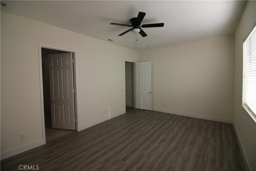 805 Annandale Road Beaumont, CA 92223 - Photo 13 of 39 a view of empty room with wooden floor and fan