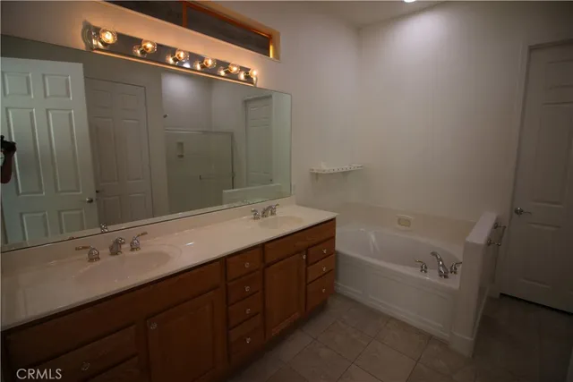 a bathroom with a tub sink and mirror