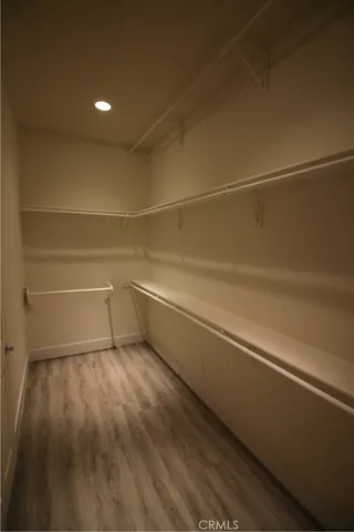 a view of a room with wooden floor and white walls