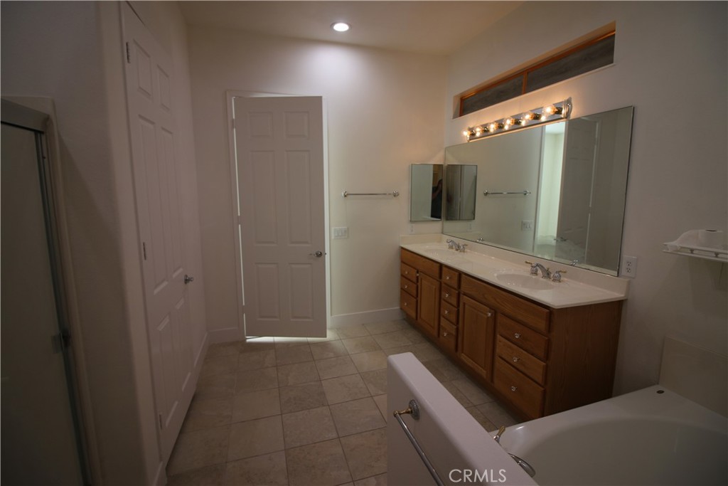805 Annandale Road Beaumont, CA 92223 - Photo 19 of 39 a bathroom with a double vanity sink and mirror