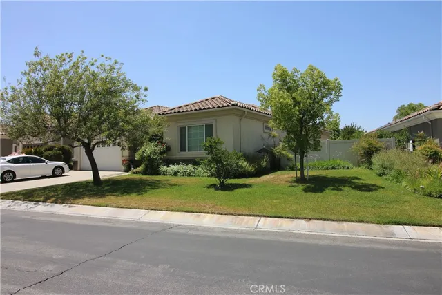 a view of a house with a yard and a street