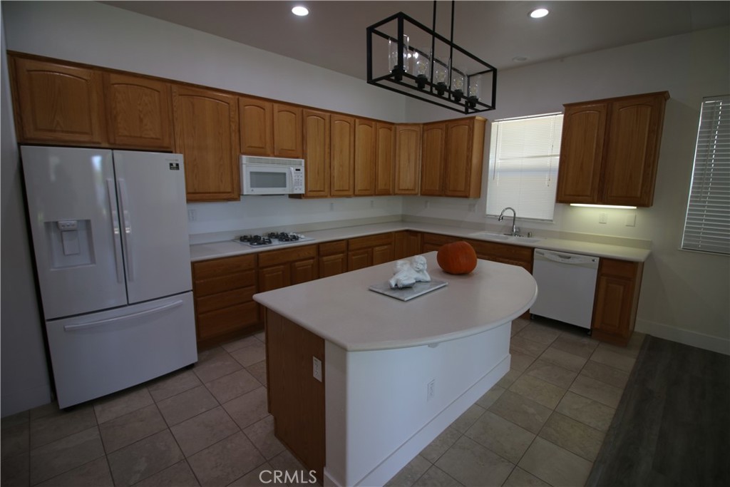 805 Annandale Road Beaumont, CA 92223 - Photo 5 of 39 a kitchen with a sink a refrigerator and a stove top oven