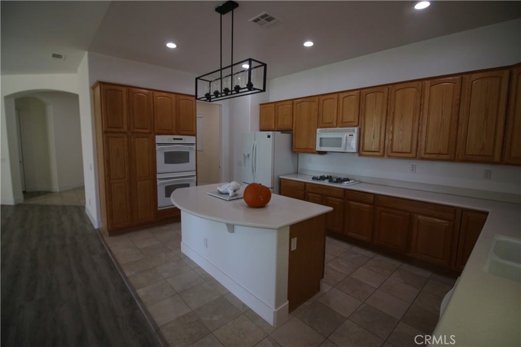 805 Annandale Road Beaumont, CA 92223 - Photo 6 of 39 a kitchen with stainless steel appliances granite countertop a refrigerator a sink a stove and a microwave