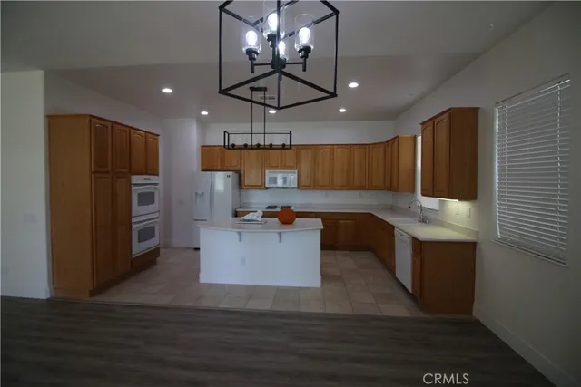 a kitchen with a refrigerator and a stove top oven