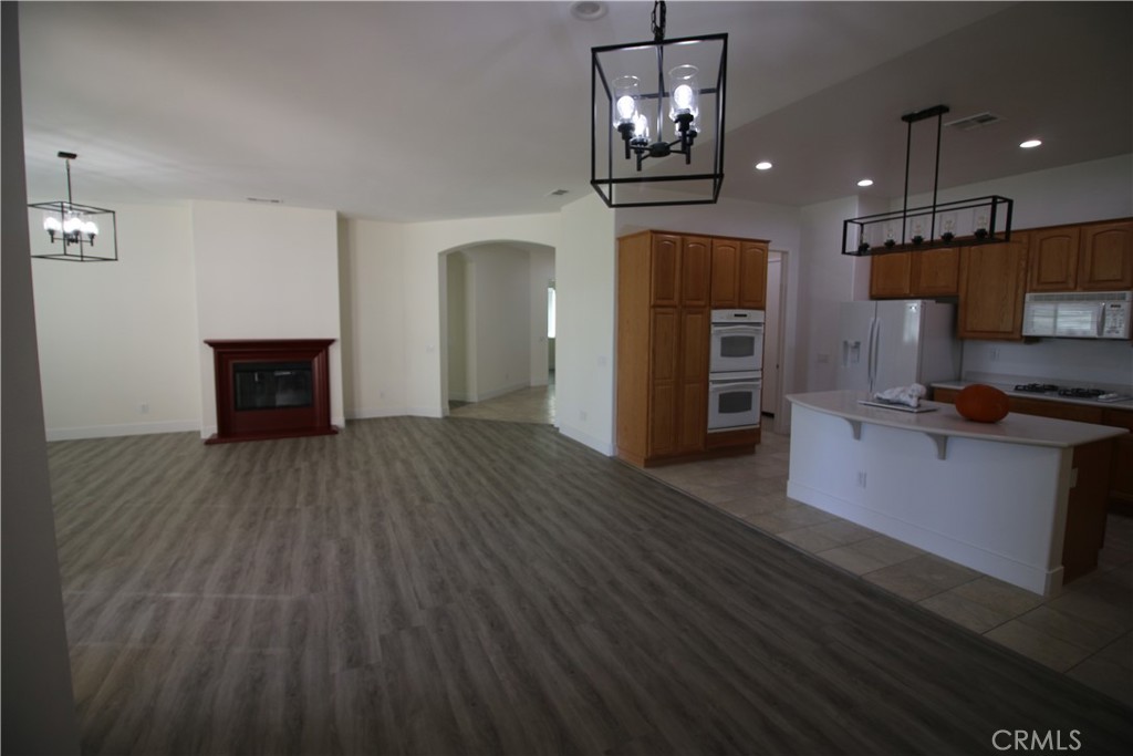 805 Annandale Road Beaumont, CA 92223 - Photo 8 of 39 a open kitchen with a refrigerator and a stove top oven