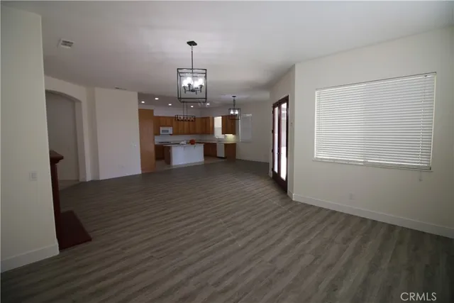 a view of a livingroom with wooden floor and stairs