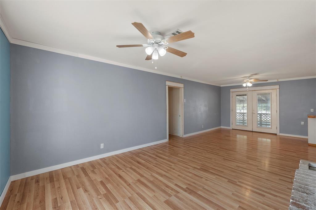 12145 Tree Lake Drive Waco, TX 76708 - Photo 11 of 40 a view of an empty room with window and wooden floor