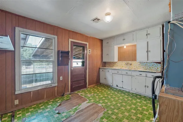 a spacious bathroom with a granite countertop sink and a mirror