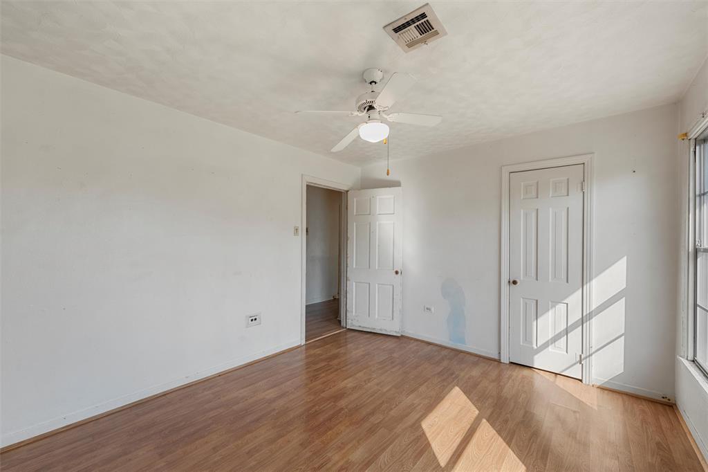 12145 Tree Lake Drive Waco, TX 76708 - Photo 21 of 40 a view of an empty room with wooden floor and a window
