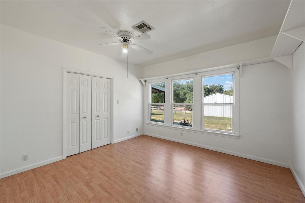 12145 Tree Lake Drive Waco, TX 76708 - Photo 23 of 40 a view of an empty room with wooden floor and a window