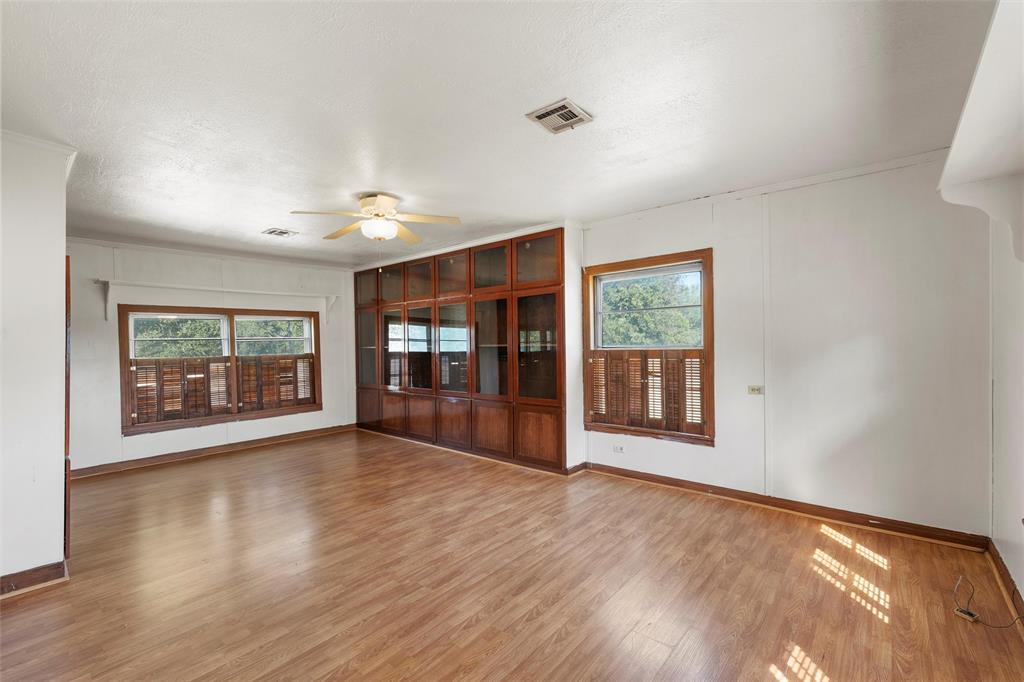 12145 Tree Lake Drive Waco, TX 76708 - Photo 24 of 40 a view of an empty room with wooden floor and a window