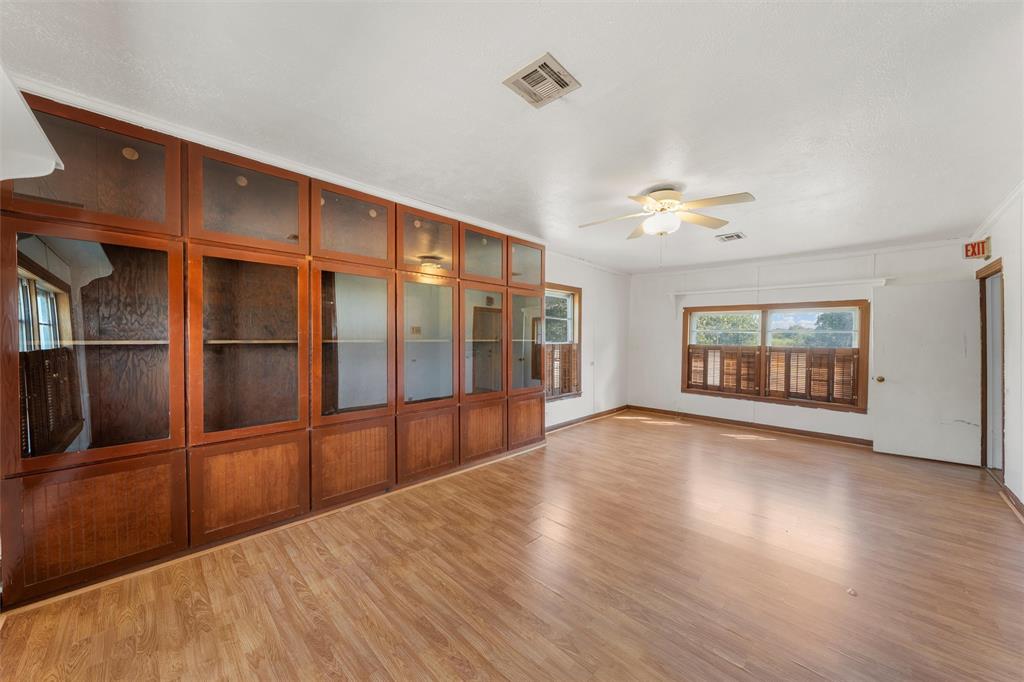 12145 Tree Lake Drive Waco, TX 76708 - Photo 25 of 40 a view of an empty room with wooden floor and a window