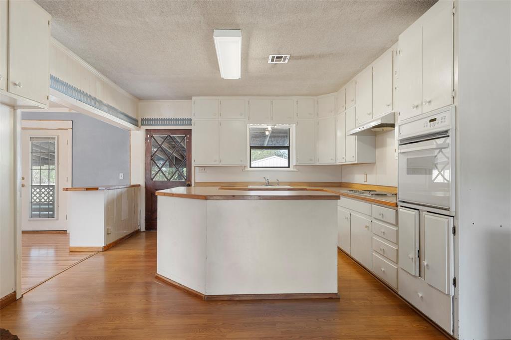12145 Tree Lake Drive Waco, TX 76708 - Photo 7 of 40 a kitchen with stainless steel appliances granite countertop a stove a sink and a refrigerator