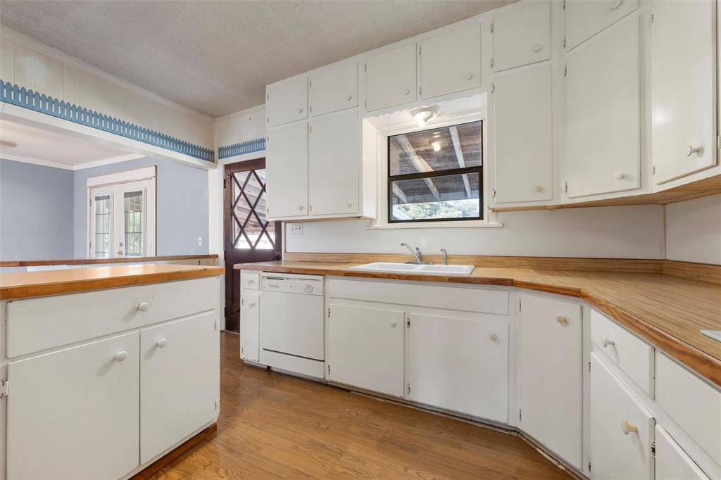 12145 Tree Lake Drive Waco, TX 76708 - Photo 8 of 40 a kitchen with sink cabinets and a window