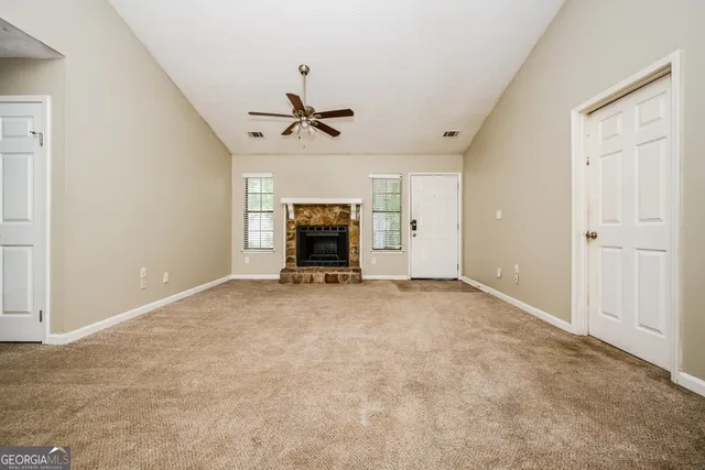 a view of empty room with a fireplace
