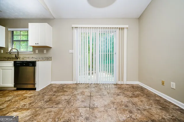 a view of a kitchen with a sink and cabinets