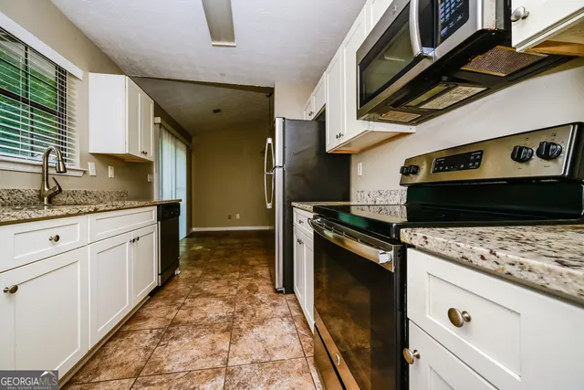 a kitchen with a stove and a refrigerator