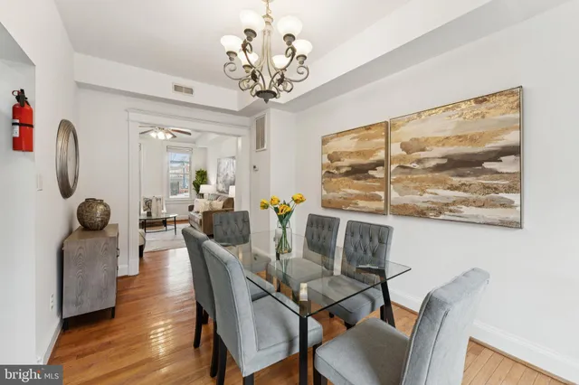 a view of a dining room with furniture wooden floor and a chandelier