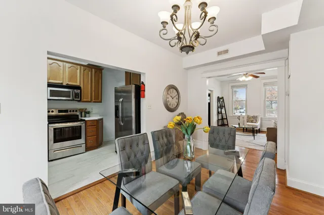 a view of a dining room with furniture wooden floor and chandelier