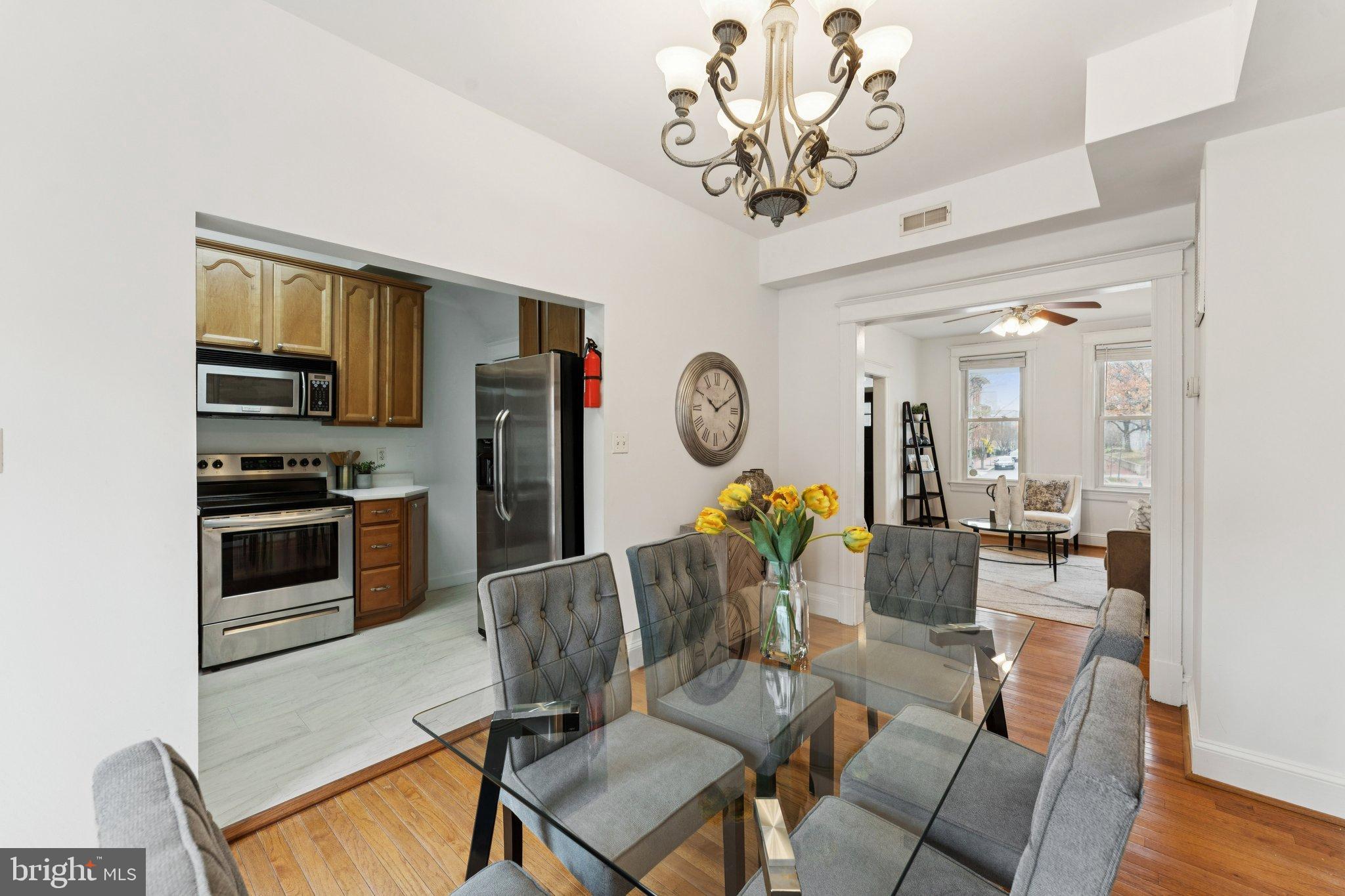 2215 2nd Street Northwest Washington, DC 20001 - Photo 11 of 34 a living room with stainless steel appliances furniture a chandelier and a view of kitchen