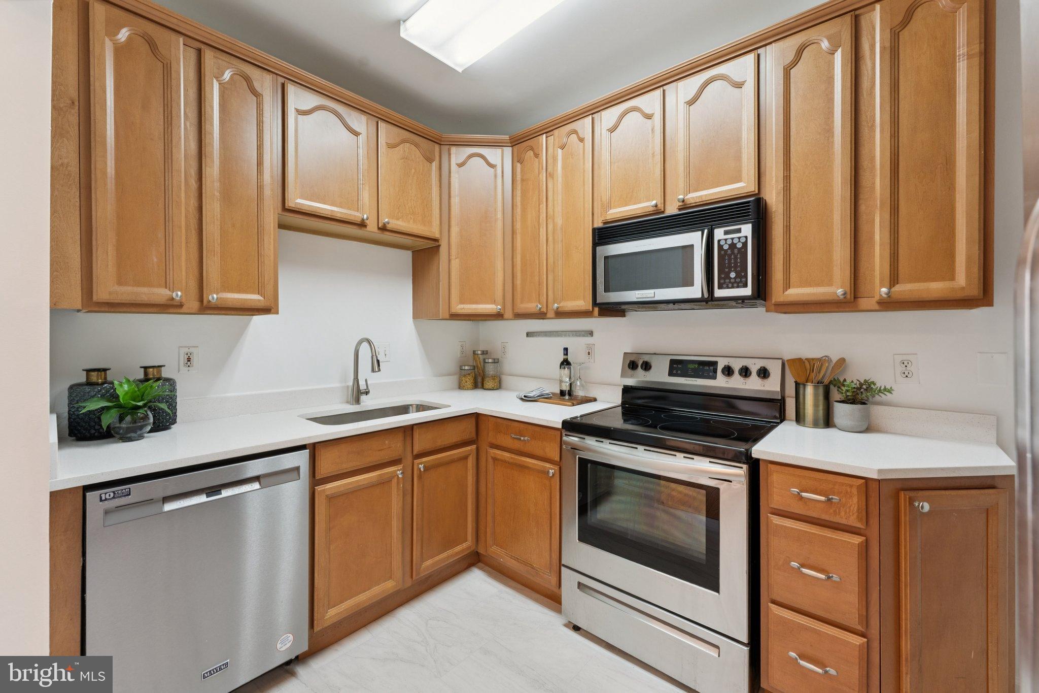 2215 2nd Street Northwest Washington, DC 20001 - Photo 13 of 34 a kitchen with granite countertop cabinets stainless steel appliances and a sink