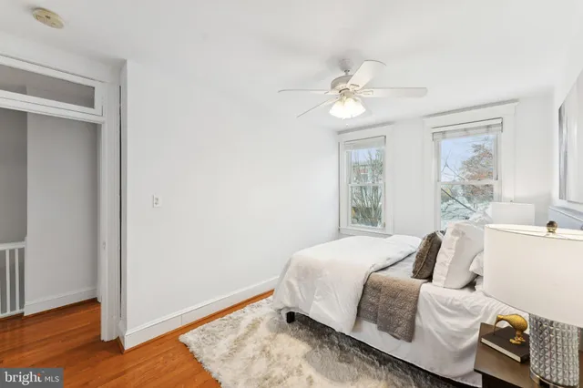 a bedroom with a bed mirror and window