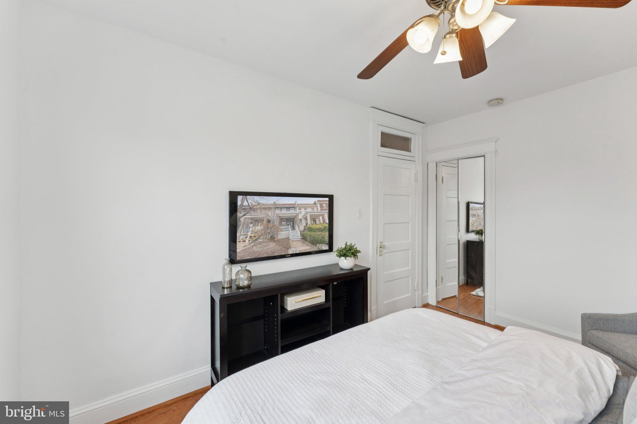 2215 2nd Street Northwest Washington, DC 20001 - Photo 22 of 34 a bedroom with a bed and a chandelier
