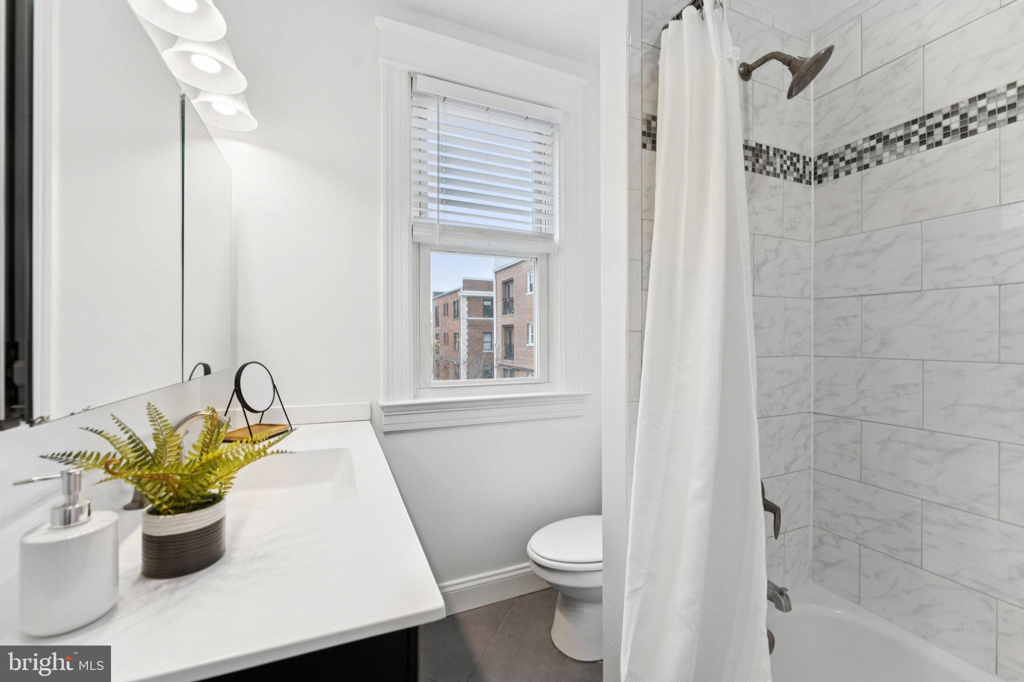 2215 2nd Street Northwest Washington, DC 20001 - Photo 25 of 34 a white bath tub sitting next to a white toilet