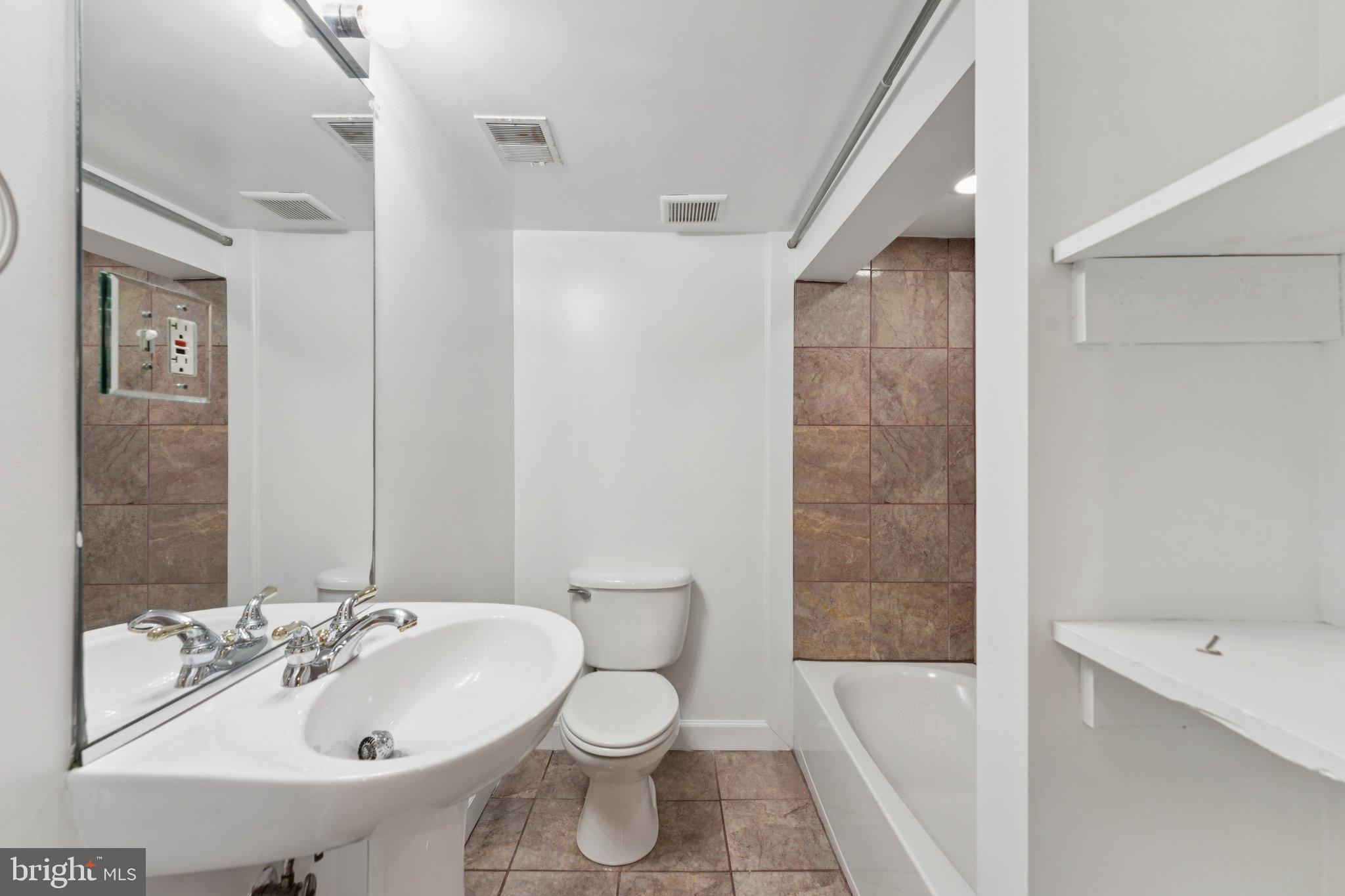 2215 2nd Street Northwest Washington, DC 20001 - Photo 29 of 34 a bathroom with a sink toilet and shower