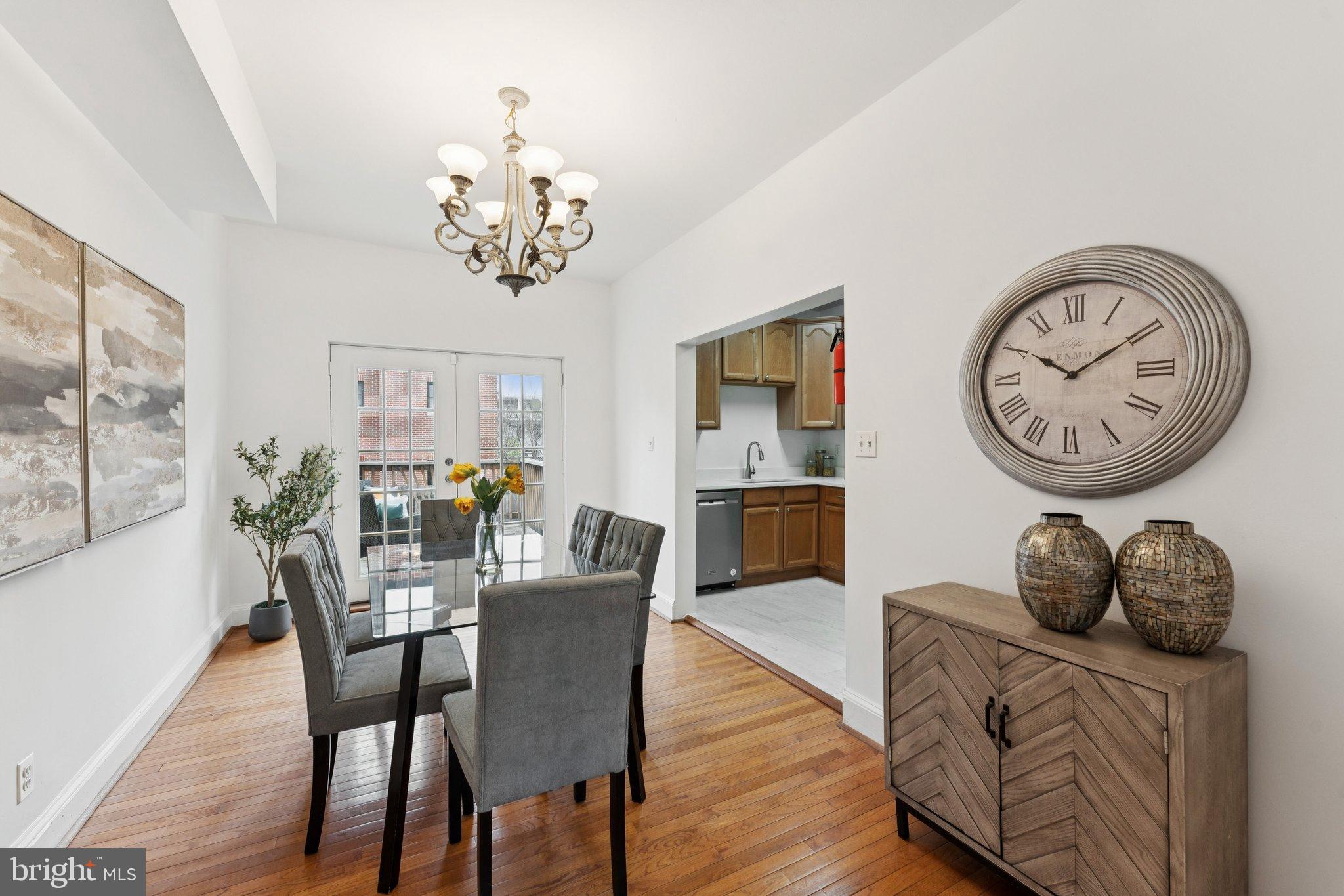 2215 2nd Street Northwest Washington, DC 20001 - Photo 8 of 34 a dining room with wooden floor a chandelier a wooden table and chairs