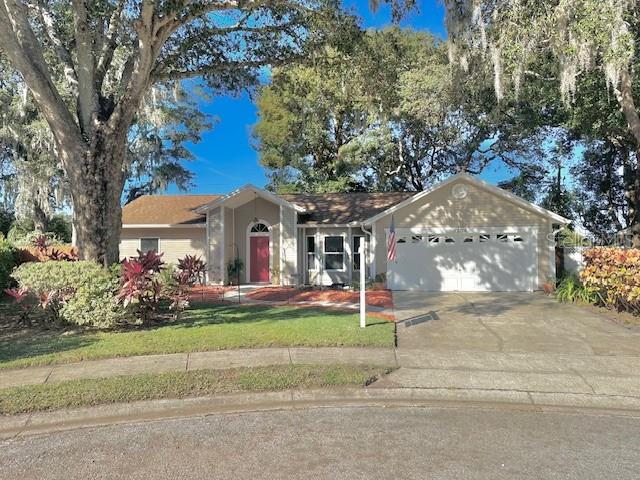 front view of house with a yard and potted plants