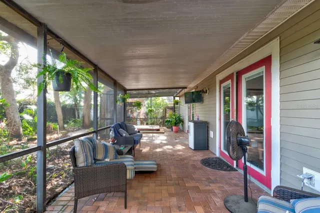 a view of a porch with furniture and floor to ceiling window