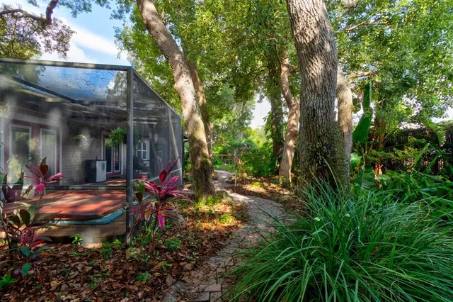 a backyard of a house with barbeque oven table and chairs