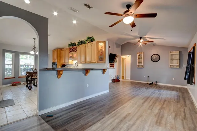 a view of kitchen with wooden floor and a ceiling fan