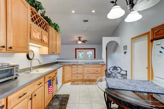 a kitchen with a stove a sink and a refrigerator