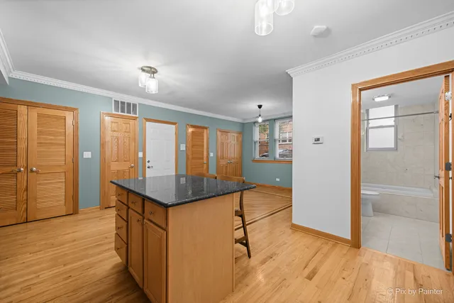 a kitchen with stainless steel appliances granite countertop wooden cabinets a stove a sink and a refrigerator