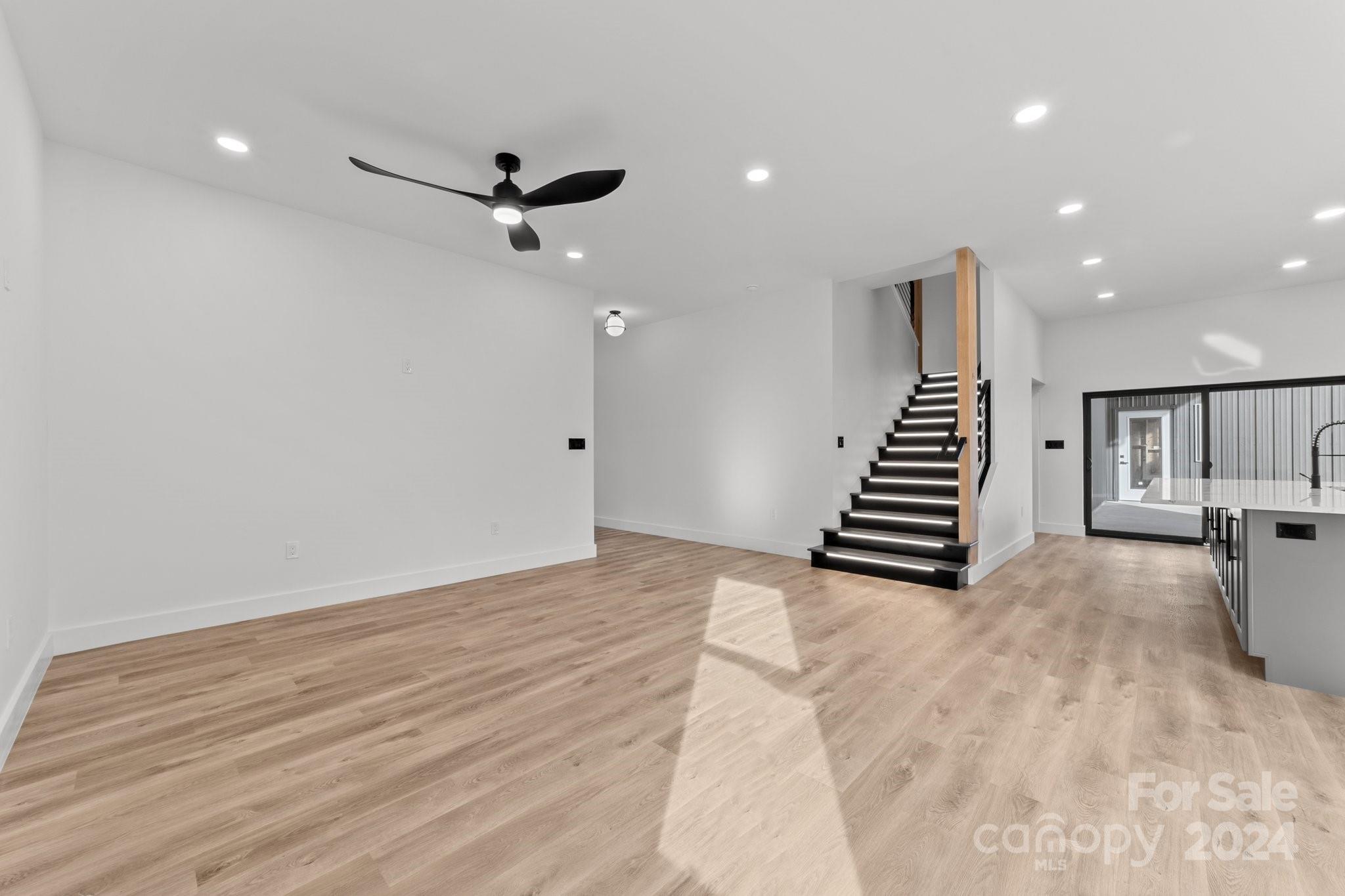 9288 Sherrills Ford Road Terrell, NC 28682 - Photo 15 of 47 a view of an empty room with wooden floor and stairs