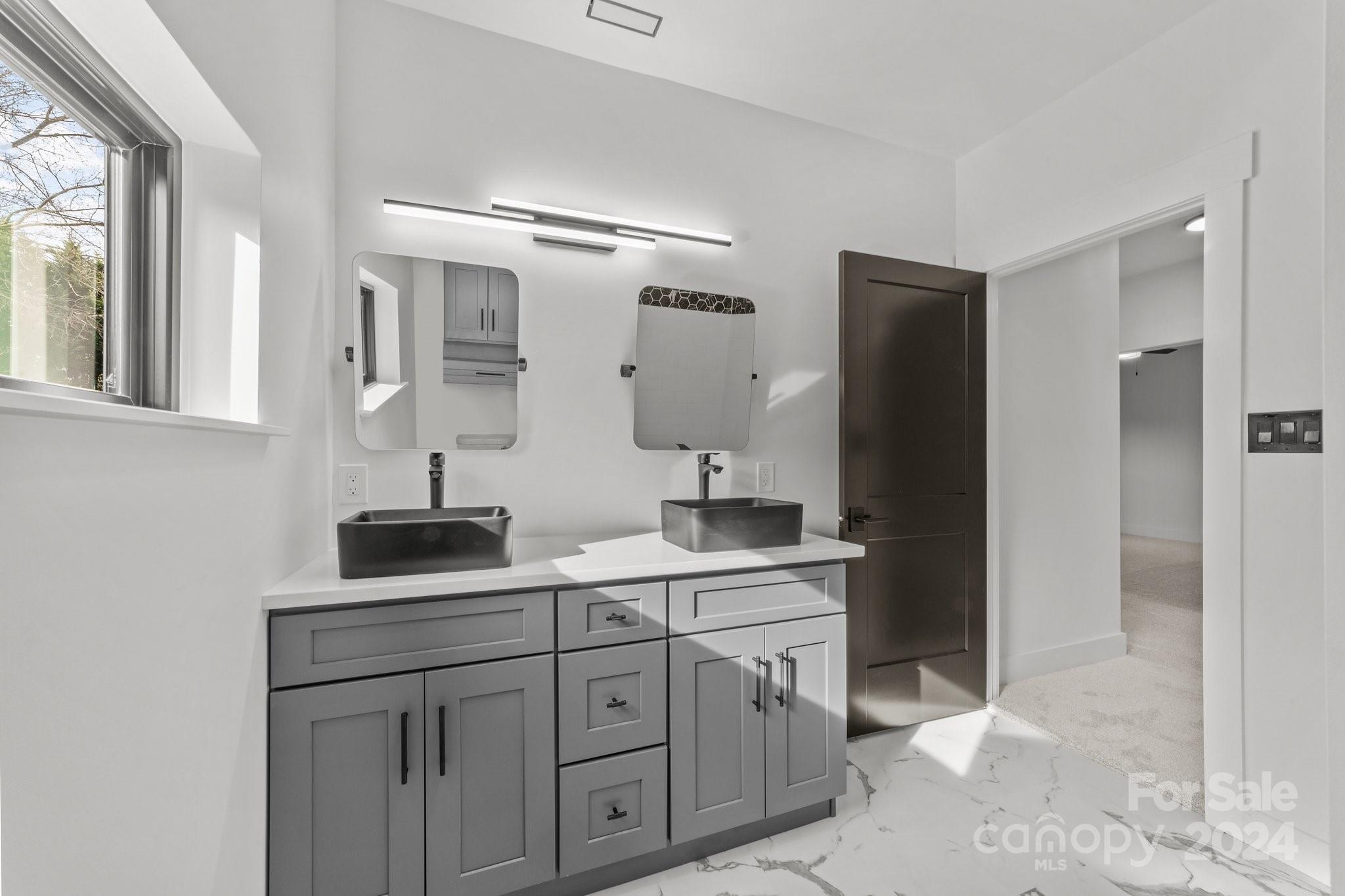 9288 Sherrills Ford Road Terrell, NC 28682 - Photo 28 of 47 a spacious bathroom with double vanity a mirror and a shower