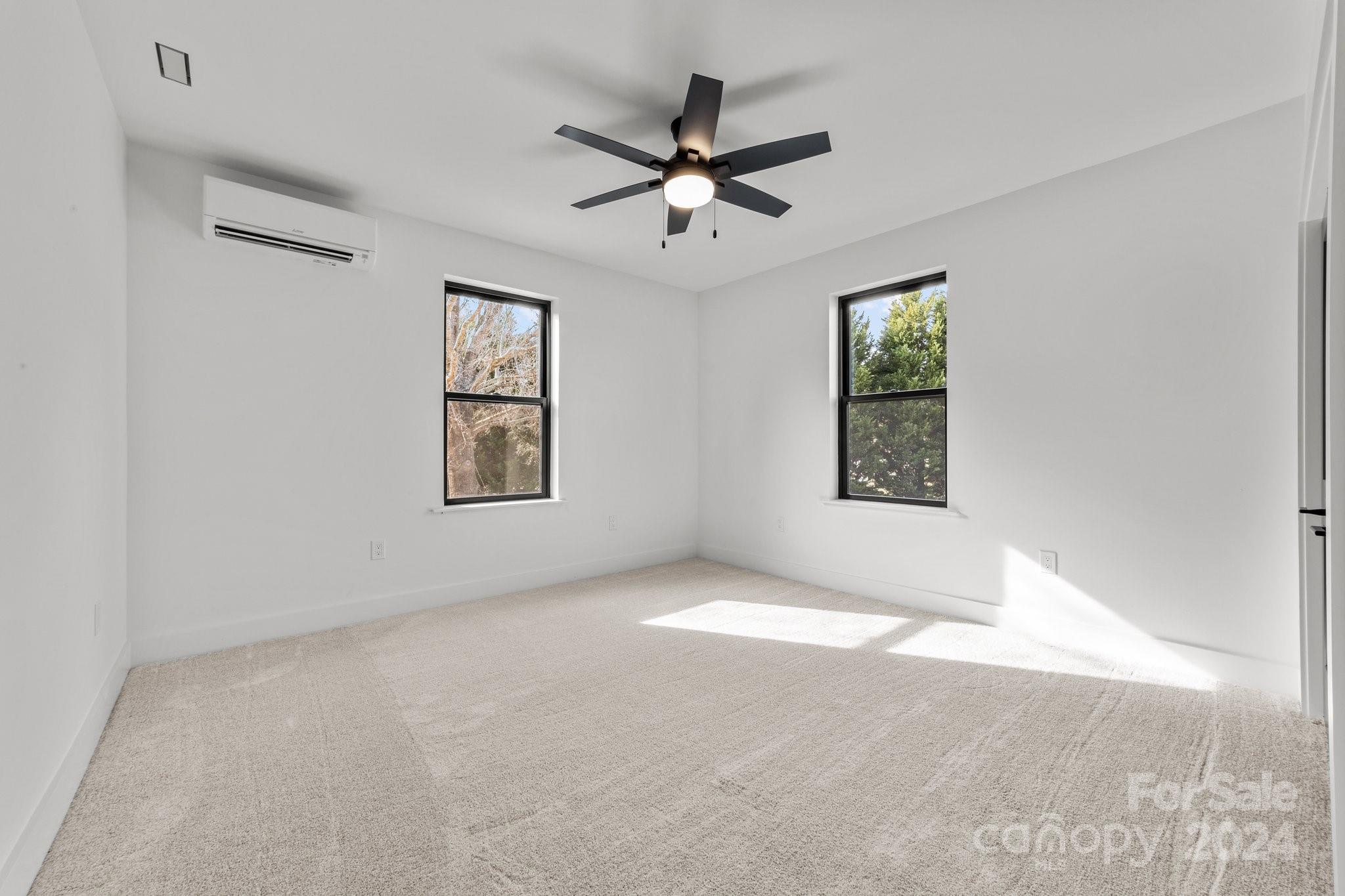 9288 Sherrills Ford Road Terrell, NC 28682 - Photo 29 of 47 an empty room with windows and ceiling fan