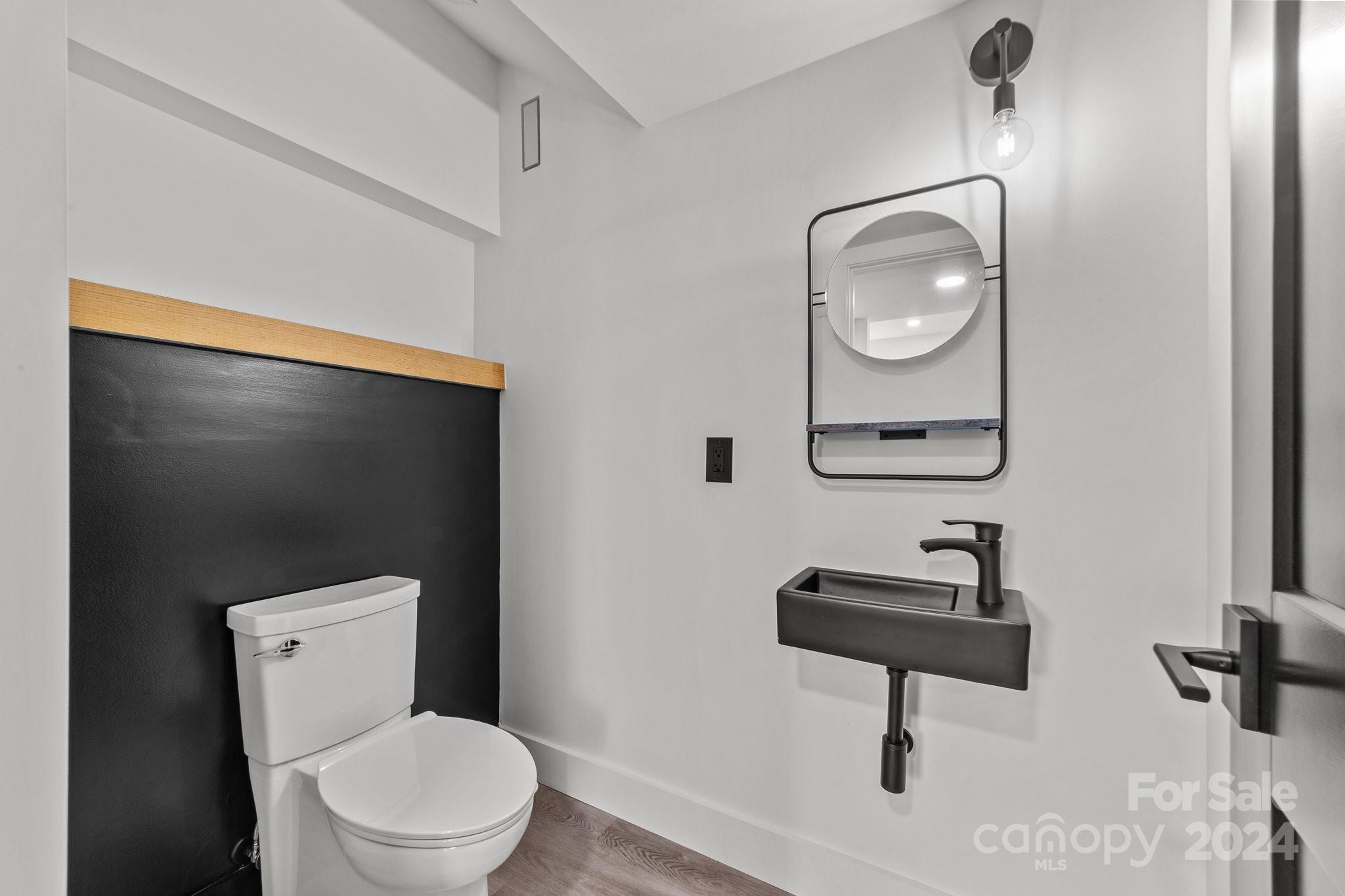 9288 Sherrills Ford Road Terrell, NC 28682 - Photo 32 of 47 a bathroom with a toilet a sink and mirror