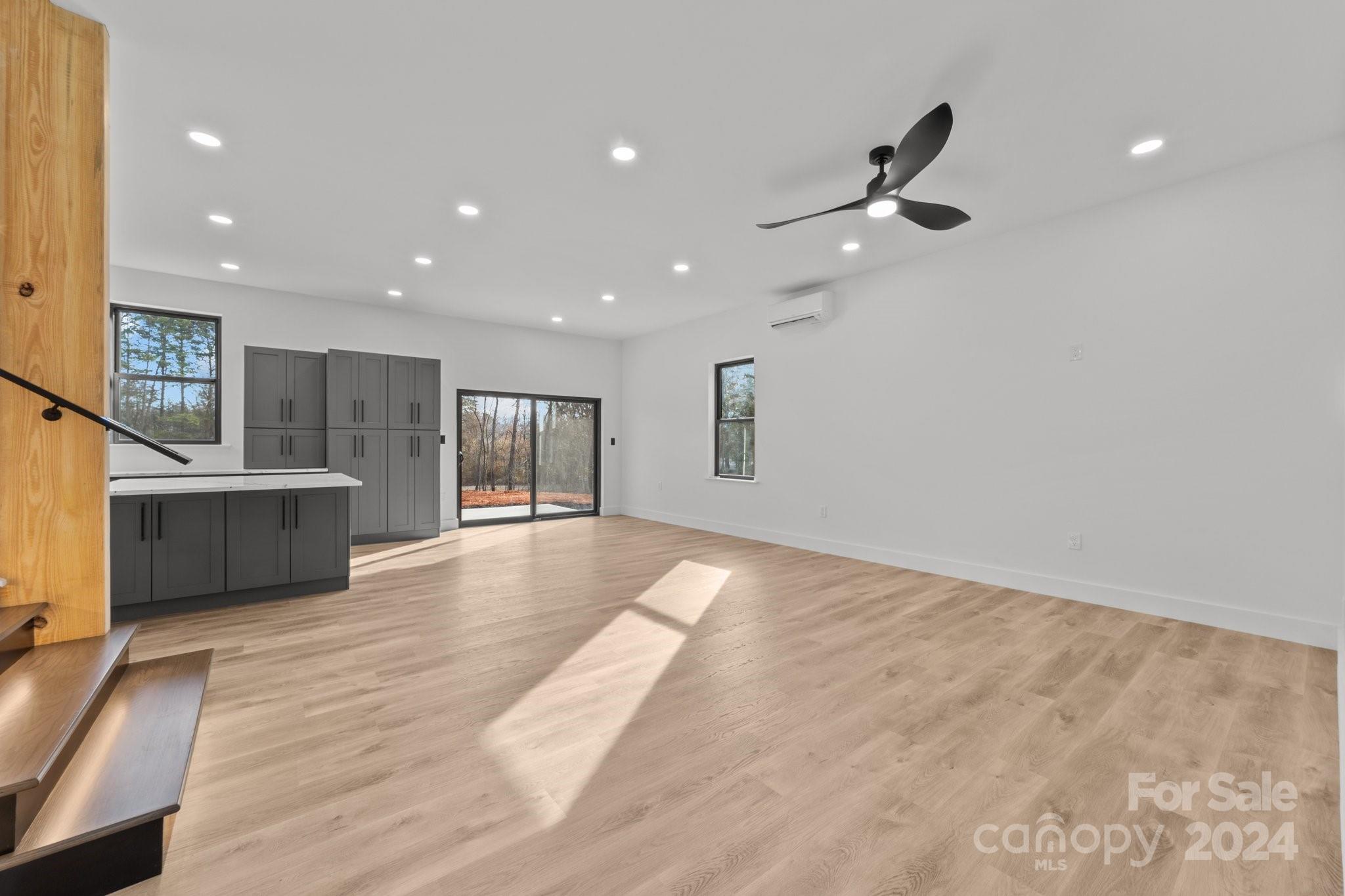 9288 Sherrills Ford Road Terrell, NC 28682 - Photo 8 of 47 a view of an empty room with wooden floor and a ceiling fan