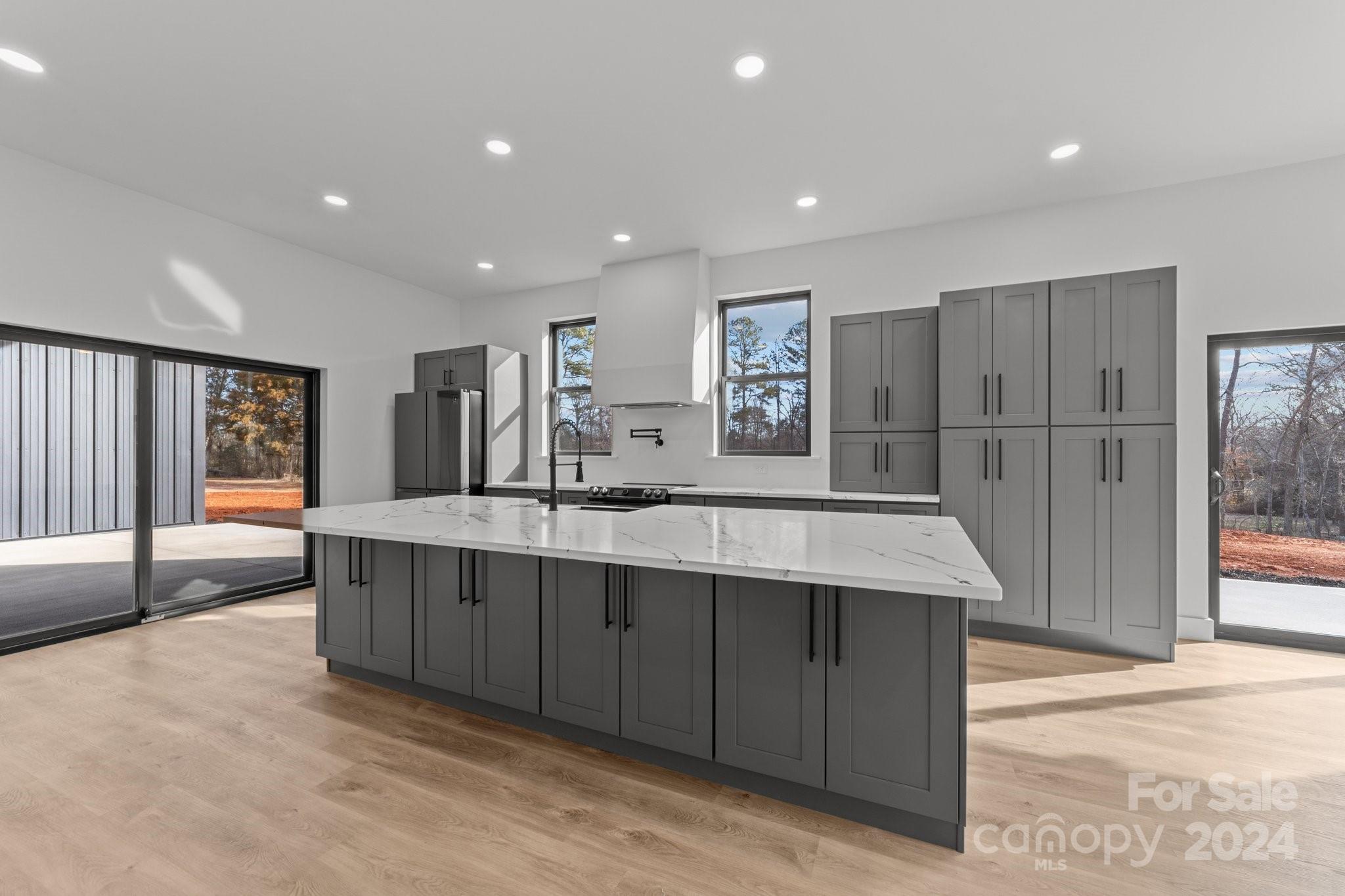 9288 Sherrills Ford Road Terrell, NC 28682 - Photo 9 of 47 a large kitchen with stainless steel appliances granite countertop a large counter top a sink and a refrigerator