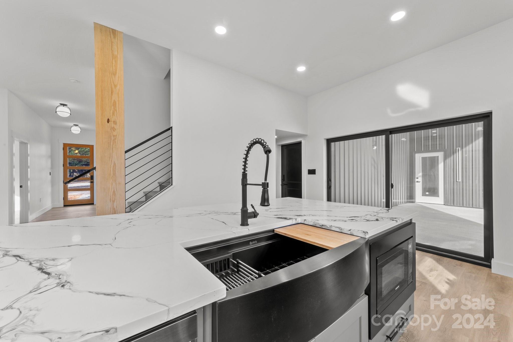 9288 Sherrills Ford Road Terrell, NC 28682 - Photo 10 of 47 a view of a kitchen island a sink a counter space and wooden floor