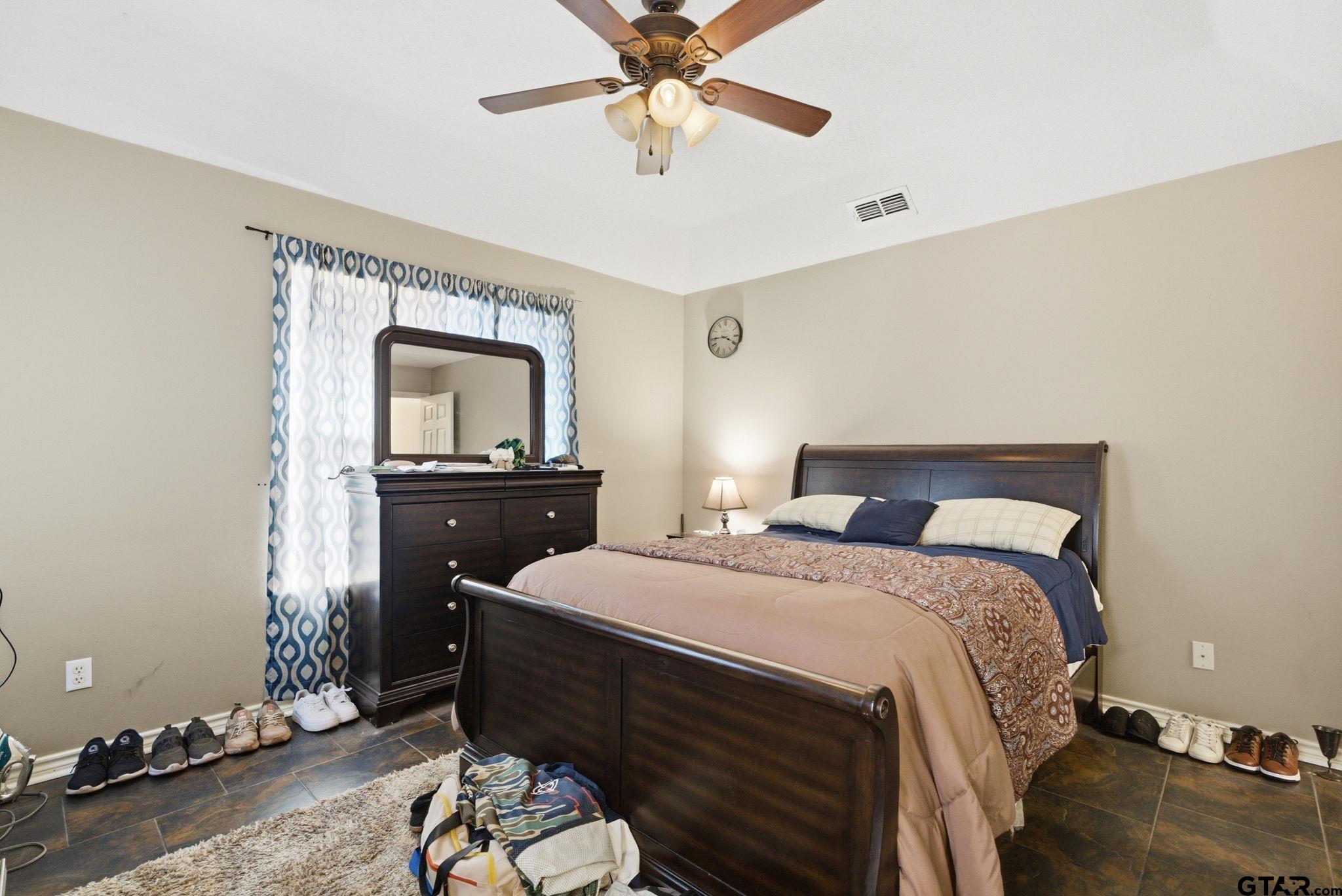 2301 McDonald Road Tyler, TX 75701 - Photo 12 of 26 a bedroom with a bed and a dresser