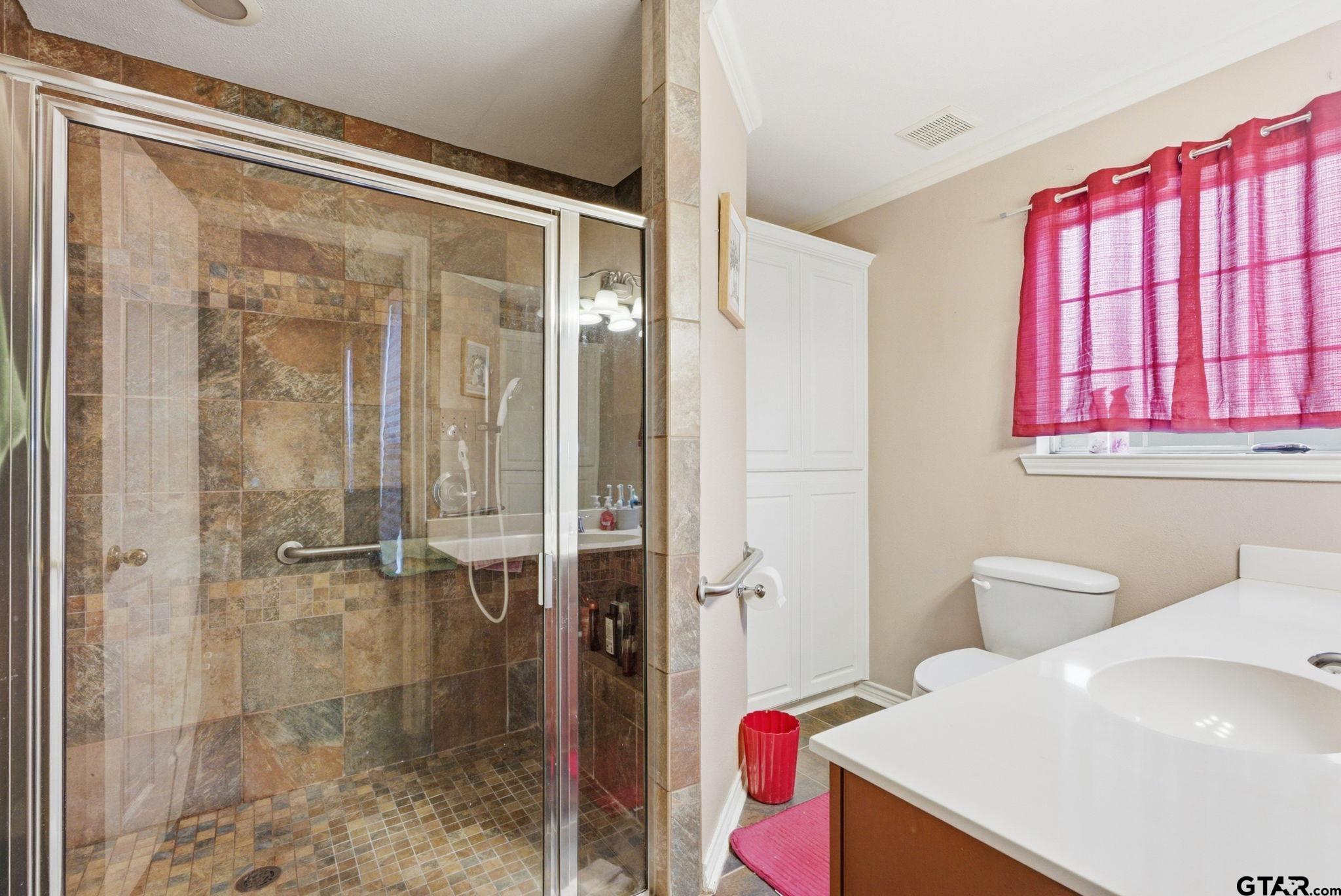 2301 McDonald Road Tyler, TX 75701 - Photo 13 of 26 a bathroom with a shower and a sink